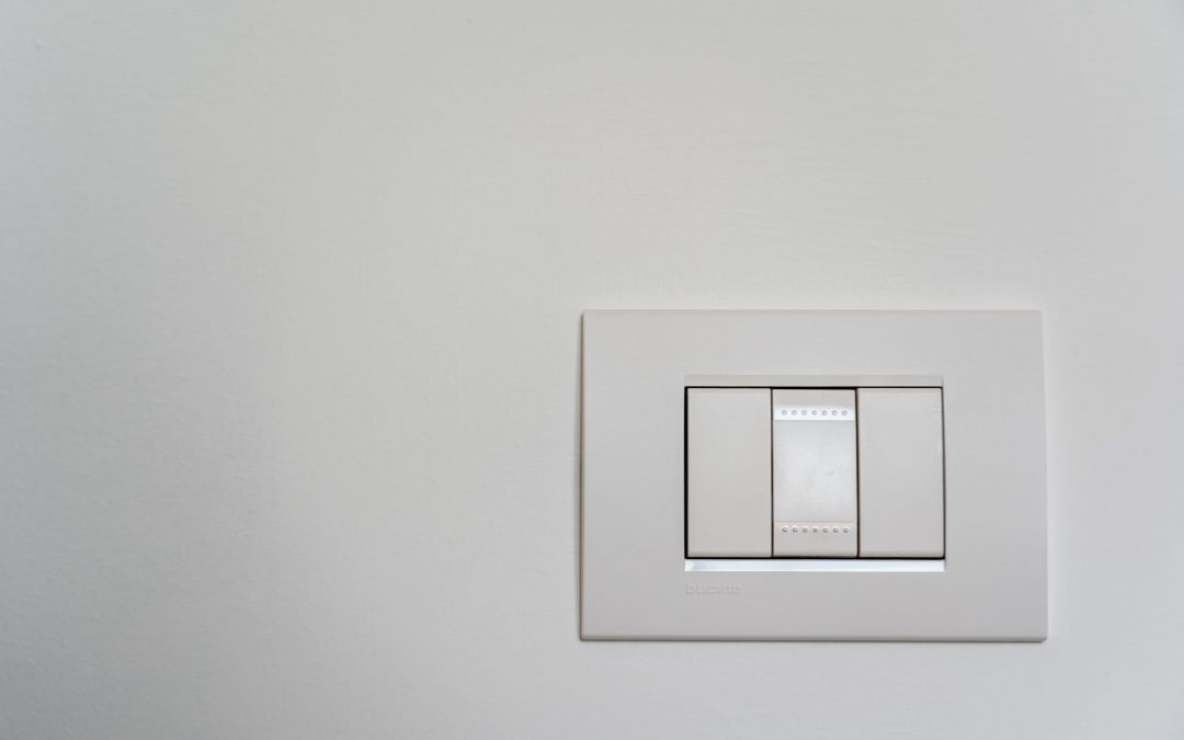 white light switch on white painted wall